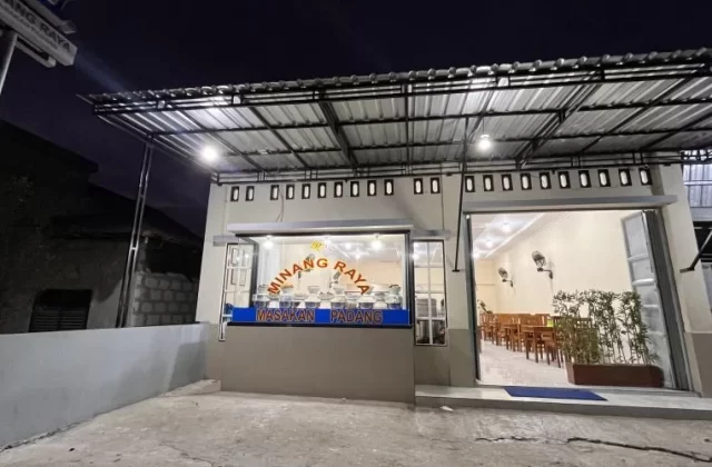 The brightly lit exterior of MR Restaurant in Tambolaka, Sumba, shows its open entrance, a food display counter, and an inviting dining area at night.